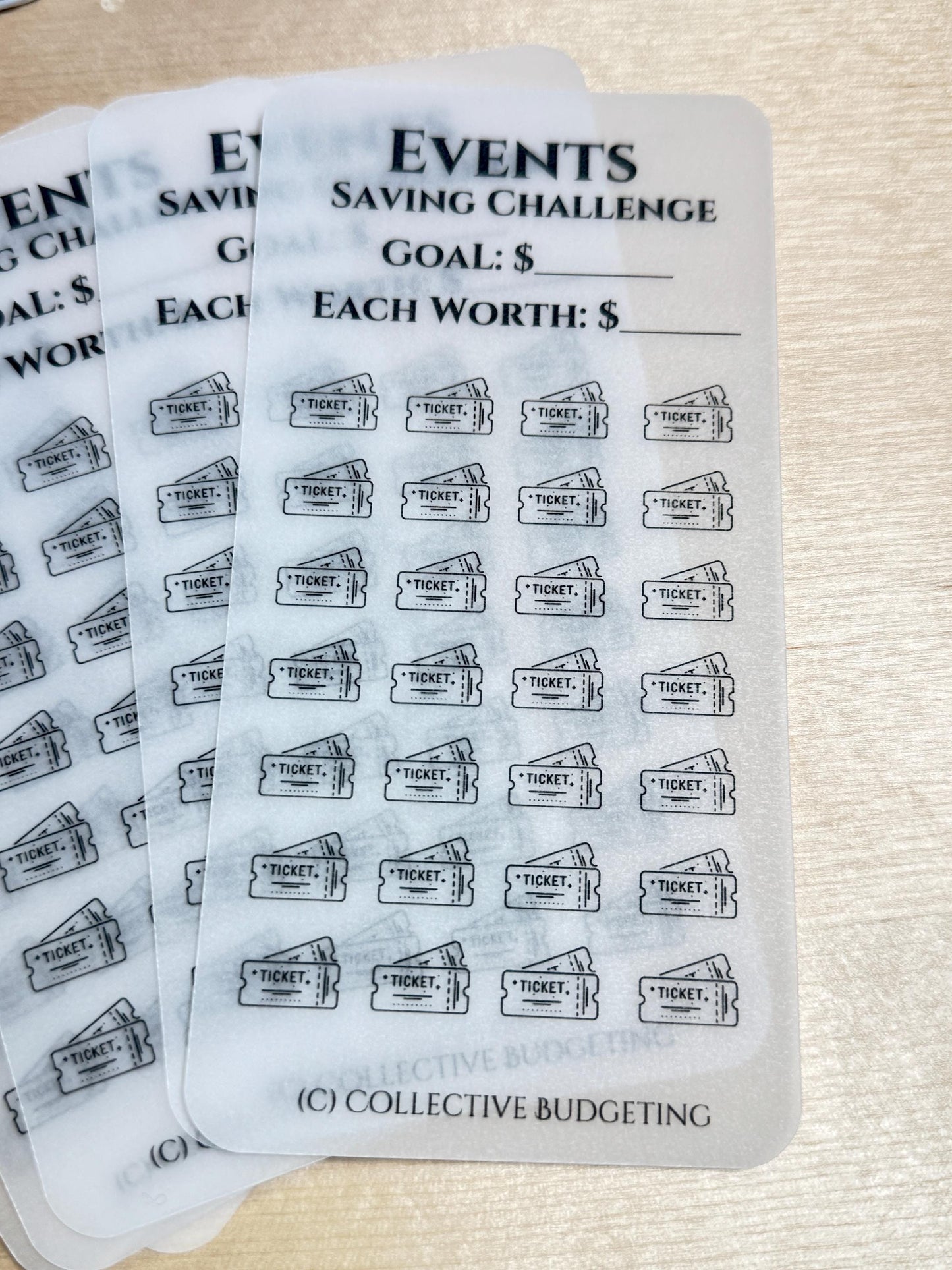 A clear sheet of stickers with the text 'Events Saving Challenge' and 'Goal: $' and 'Each Worth: $'. The sheet has 49 black and white ticket icons with the text 'Ticket' on each icon.