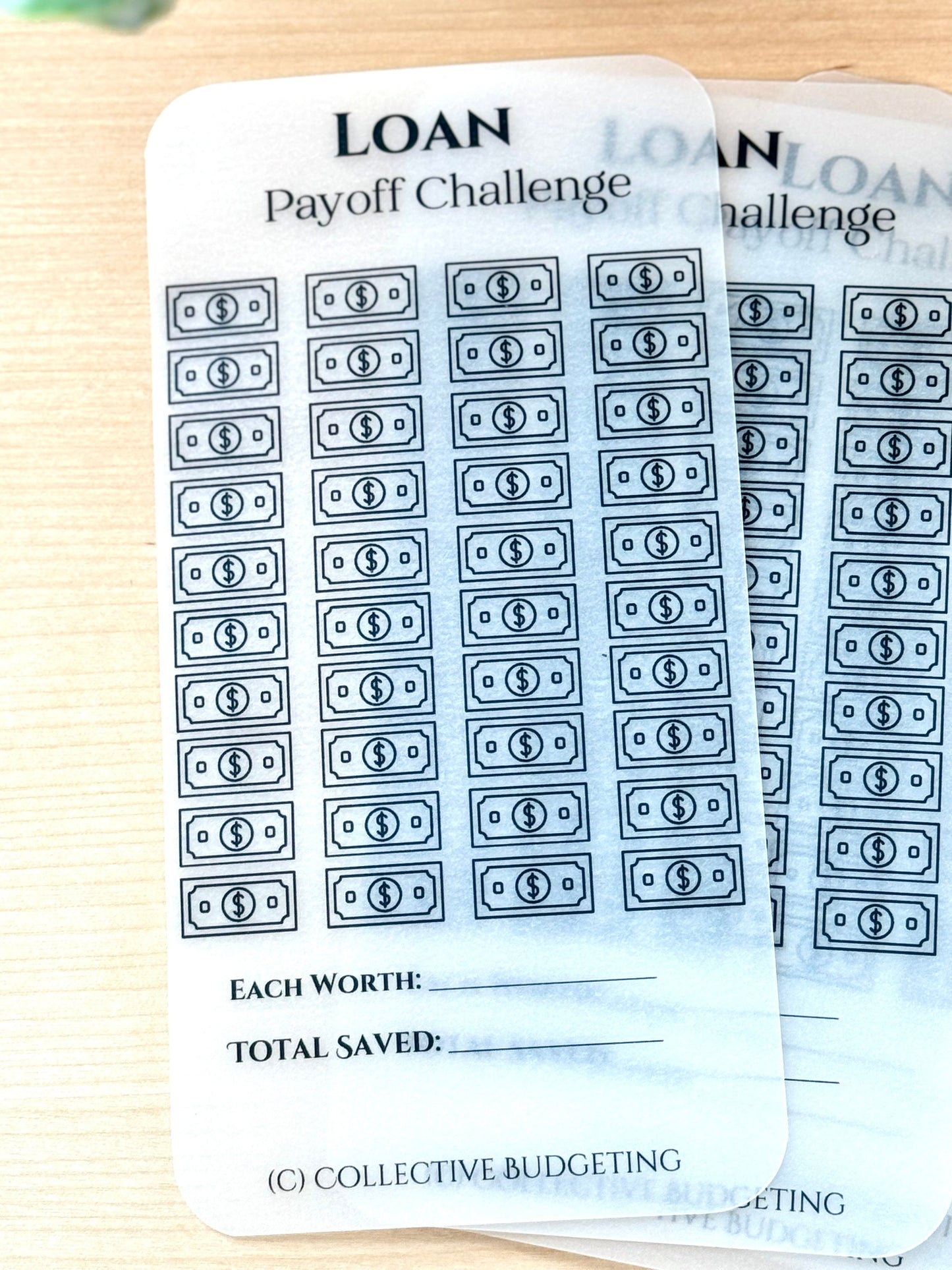 Two white sheets of paper with black text and graphics. The text reads 'LOAN Payoff Challenge' and 'EACH WORTH:' and 'TOTAL SAVED:' The graphics are black outlines of dollar bills. The bottom of the sheet reads '(C) COLLECTIVE BUDGETING'.