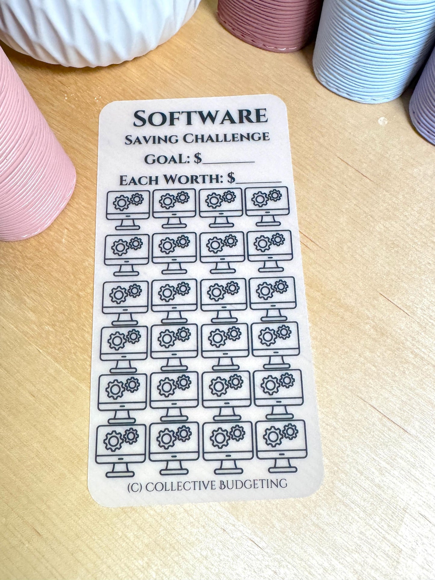 A white sticker with black text and icons. The sticker is a saving challenge for software. The text reads 'SOFTWARE SAVING CHALLENGE GOAL: $ EACH WORTH: $'. The sticker has 36 icons of a computer monitor with three gears inside. The text at the bottom of the sticker reads '(C) COLLECTIVE BUDGETING'.