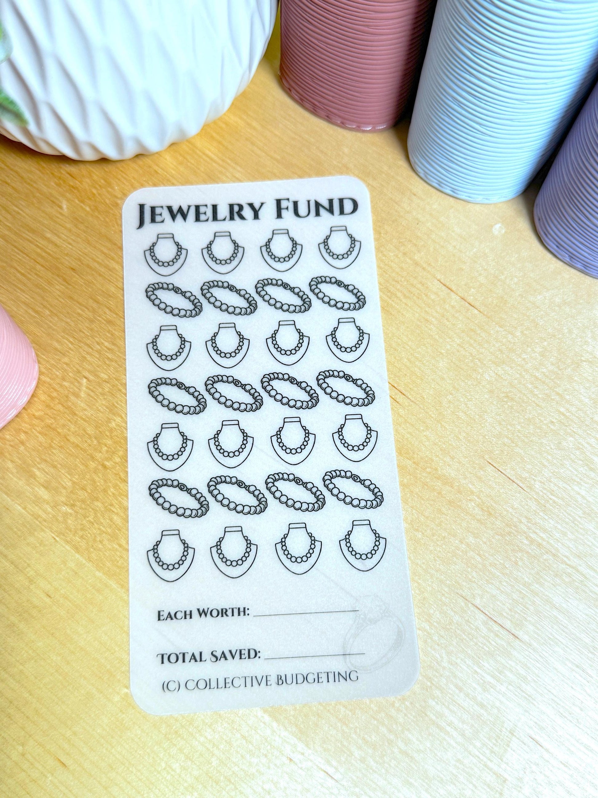 1 transparent sheet with a black and white design of necklaces. The sheets have the text 'JEWELRY FUND', 'EACH WORTH', 'TOTAL SAVED', and '(C) COLLECTIVE BUDGETING'.