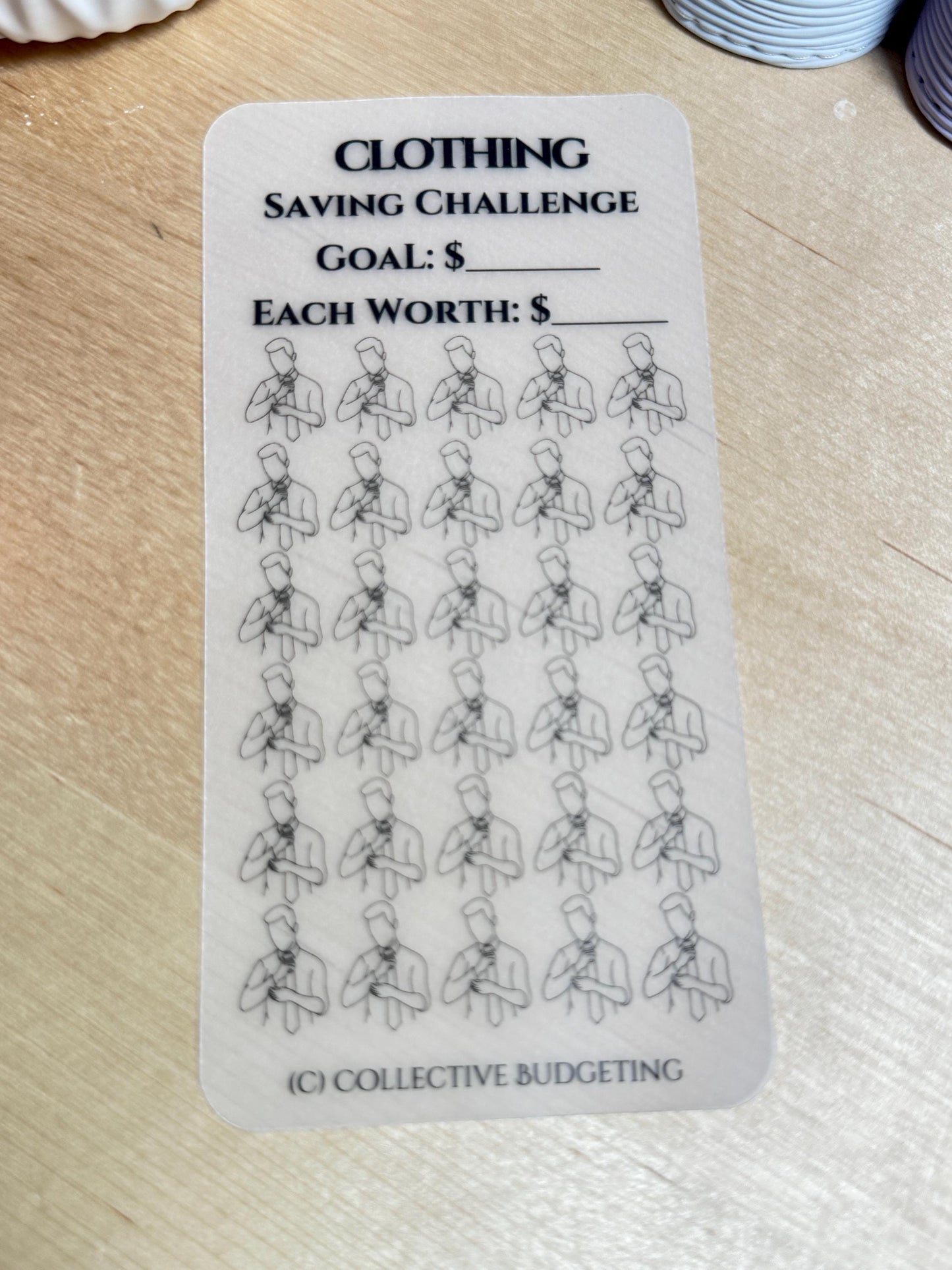 A white sticker with black text and a black line drawing of a person. The text reads 'Clothing Saving Challenge', 'Goal: $', 'Each Worth: $', and '(C) Collective Budgeting'. The sticker has 36 black line drawings of a person with a tie.