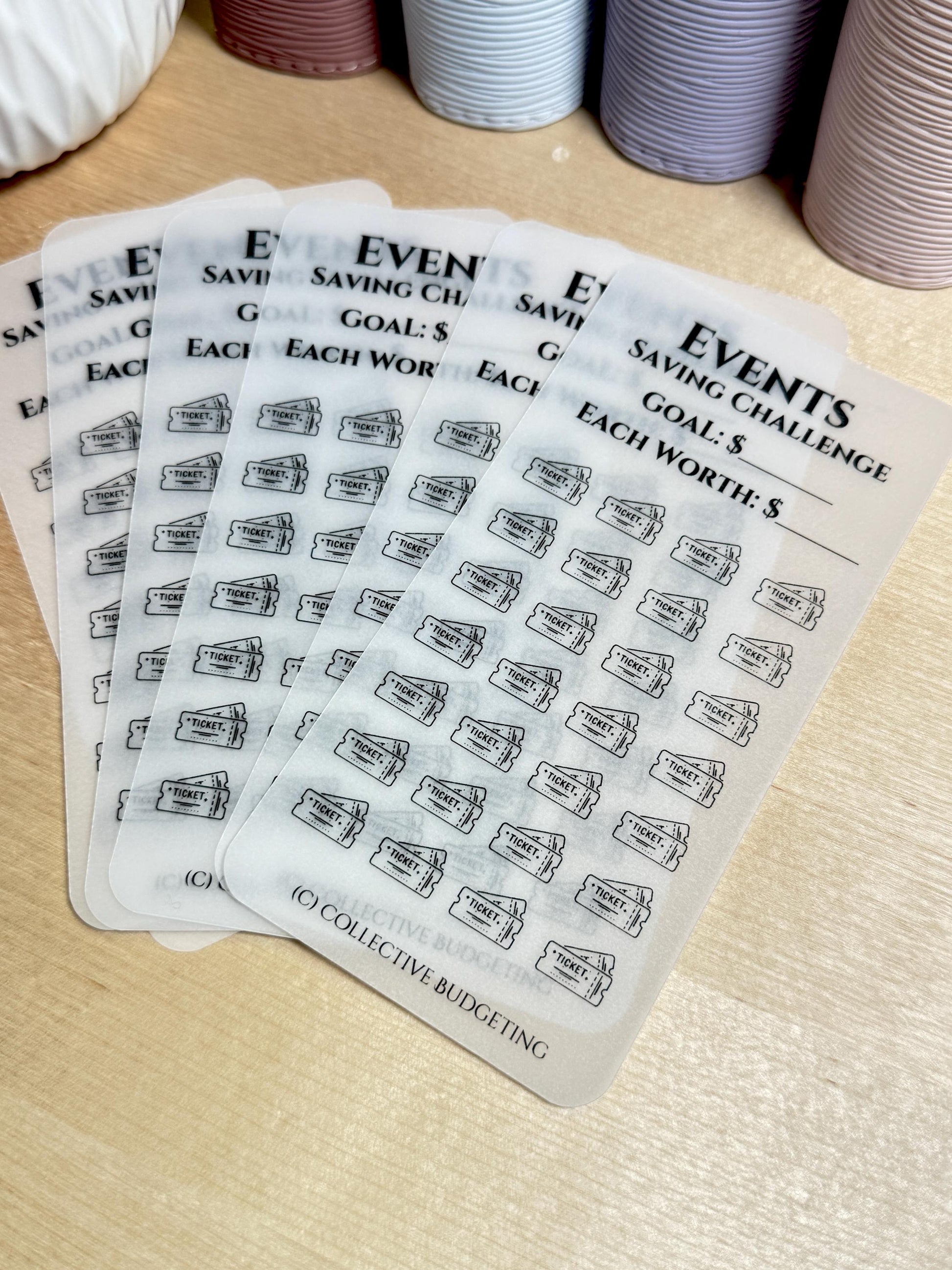 Five sheets of clear stickers with black ink. Each sheet has a title that reads 'Events Saving Challenge' and has the text 'Goal: $ Each Worth: $'. The stickers are decorated with a repeating pattern of black ticket icons.