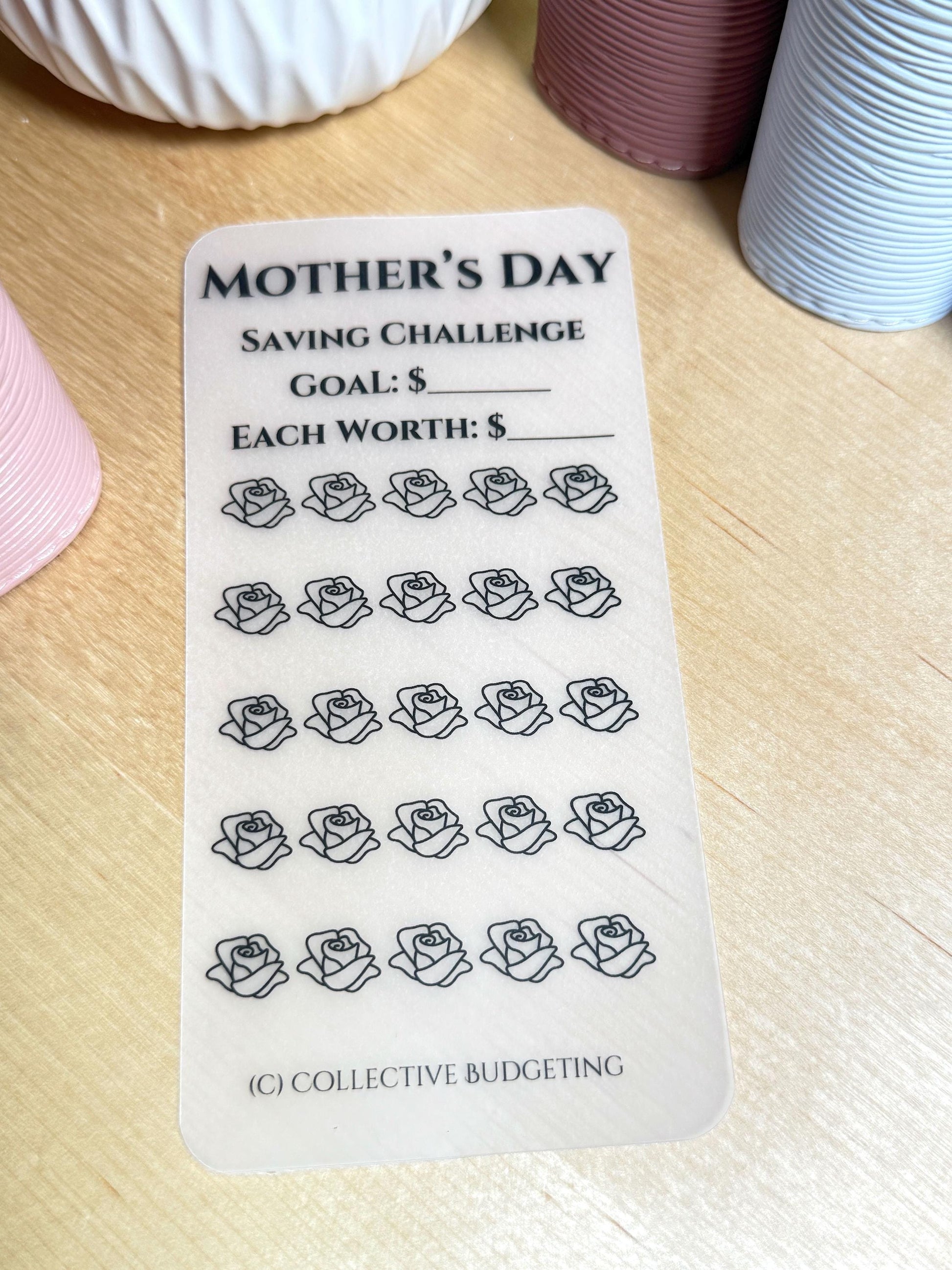 A transparent sheet with the text 'MOTHER'S DAY SAVING CHALLENGE GOAL: $ EACH WORTH: $' and 25 outlined rose images. The text '(C) COLLECTIVE BUDGETING' is at the bottom of the sheet.