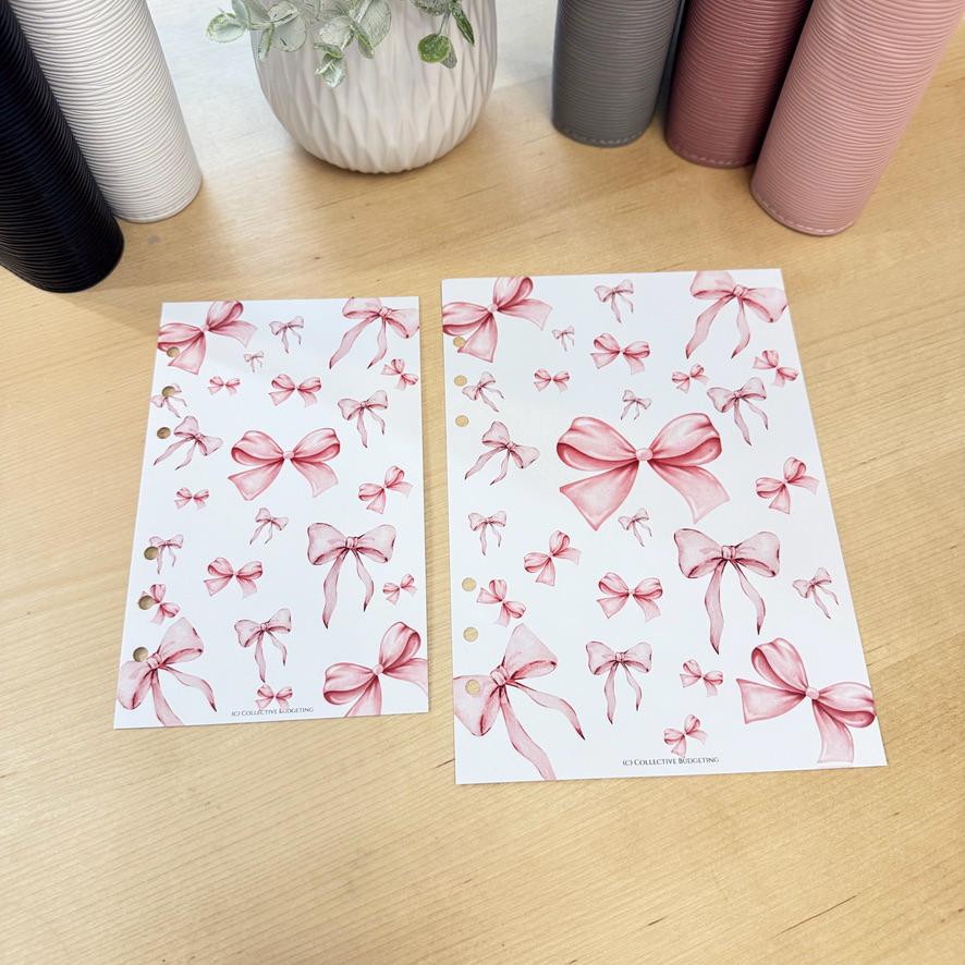 Two white sheets of paper with pink watercolor bows printed on them. The sheets have holes on the left side for a binder.