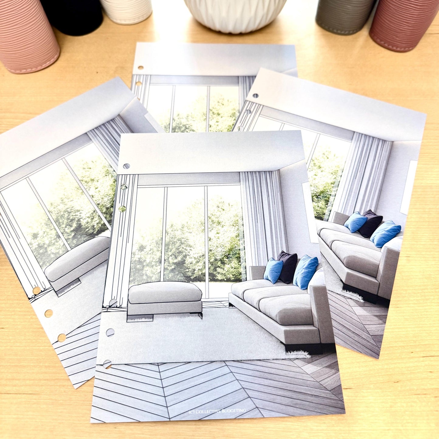 Four white pages with black lines depicting a living room with a large window, white curtains, a couch with blue pillows, and a white ottoman. The floor is a light brown wood with a herringbone pattern. The text 'Exclusive to Bloom' is at the bottom of the page.
